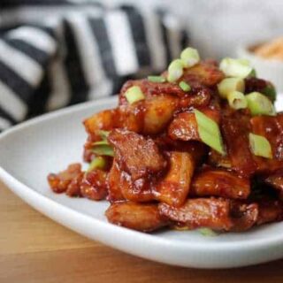 Close up of pork belly on a white plate