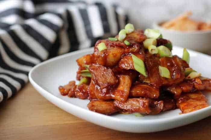 Close up of pork belly on a white plate