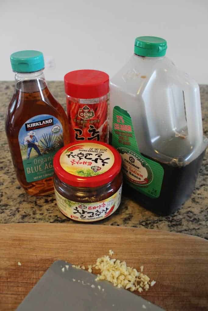 Agave, gochujang, gochugaru, and soy sauce on a countertop