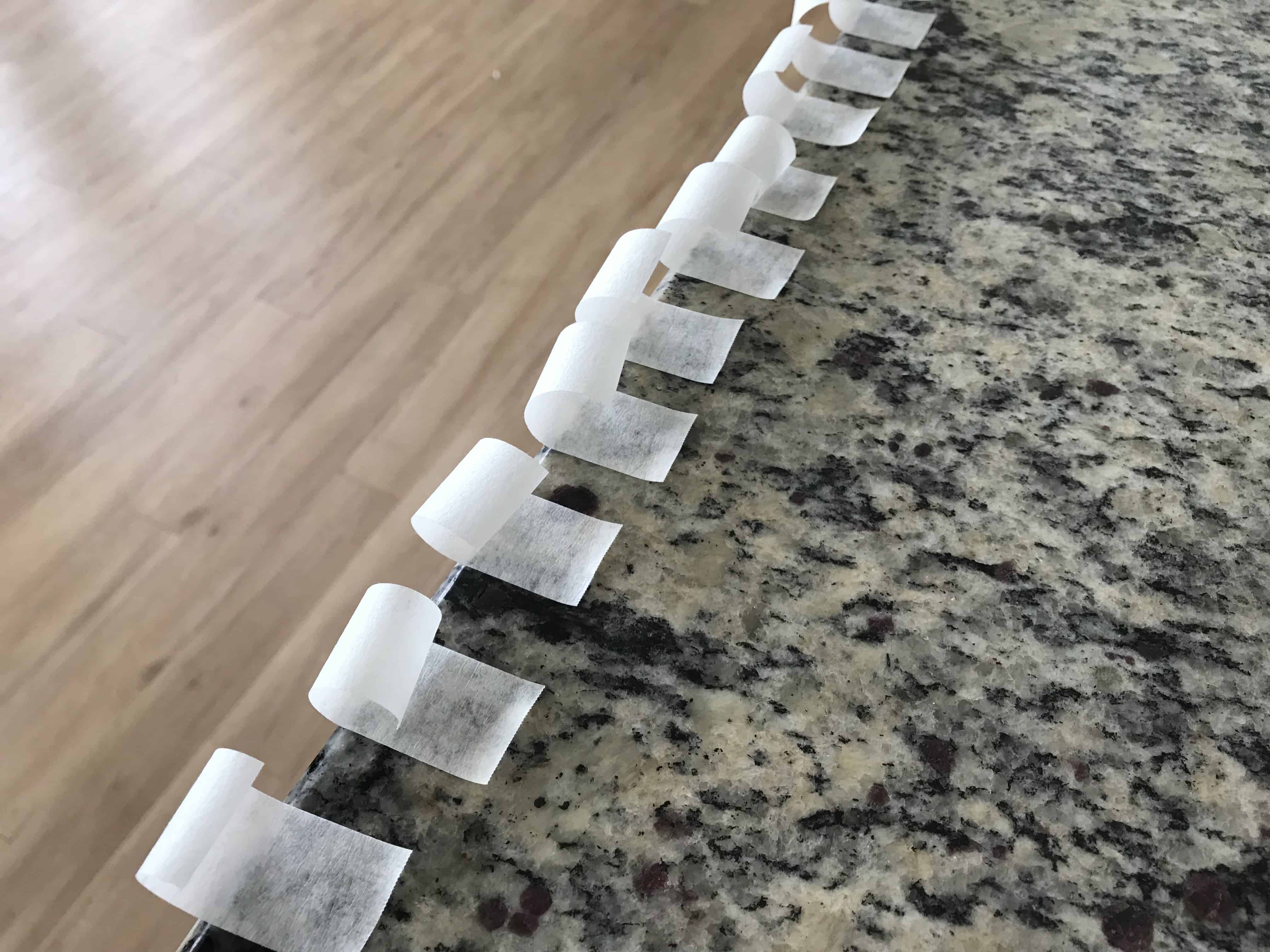 Small pieces of tape stuck to a countertop