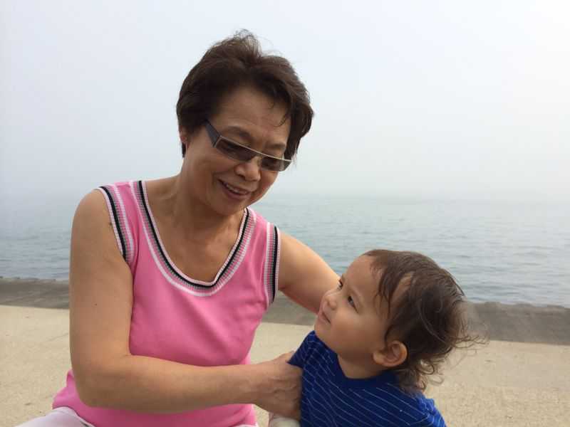 A grandmother and a grandchild staring at each other