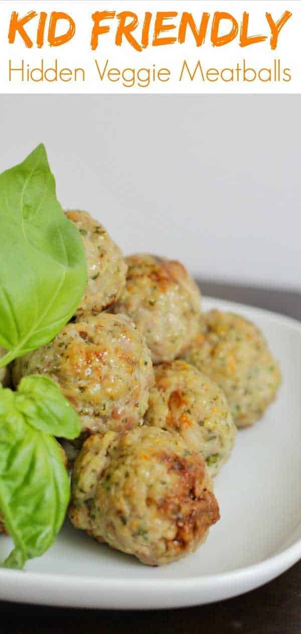 Meatballs piled on a plate with basil