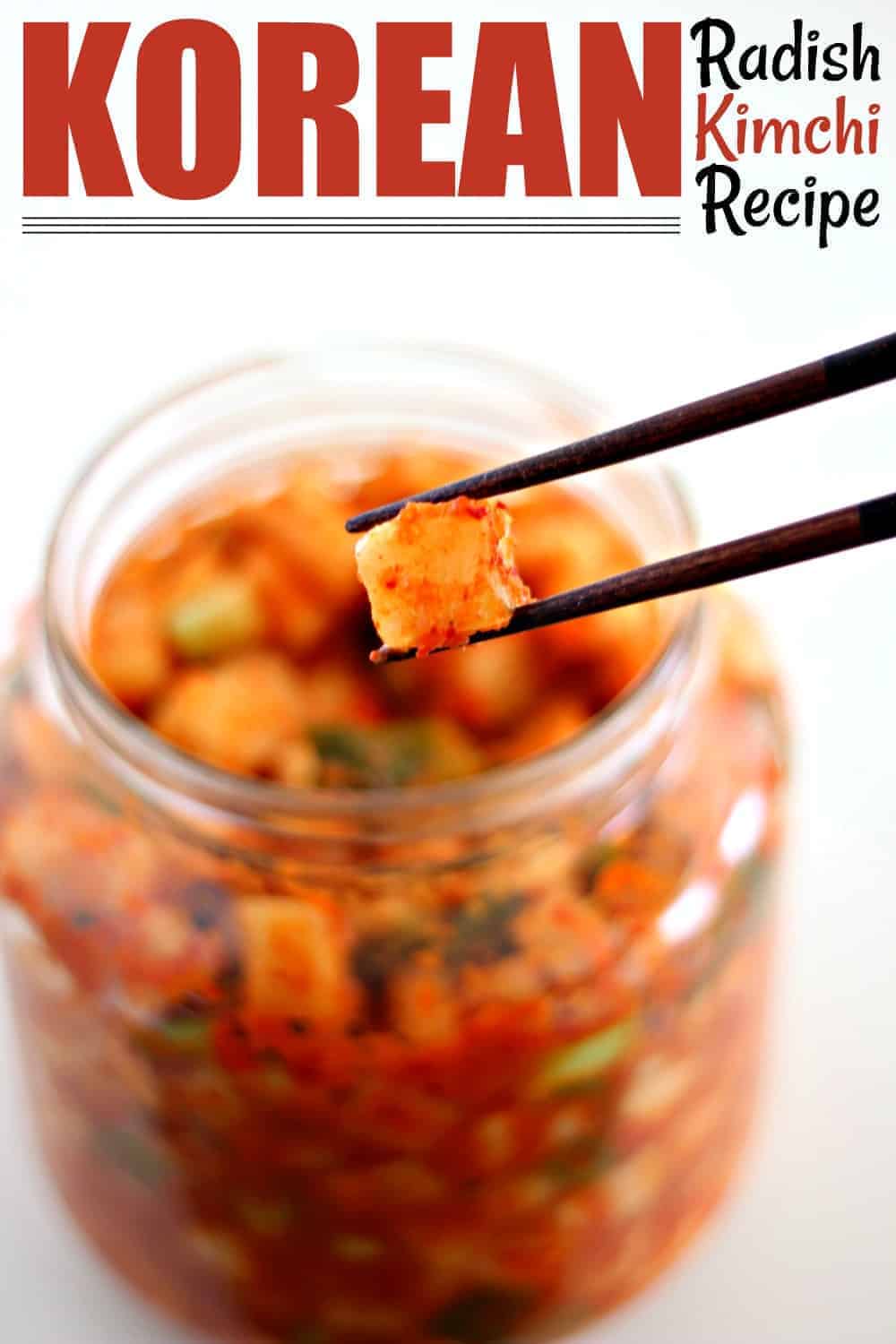 Chopsticks holding radish kimchi