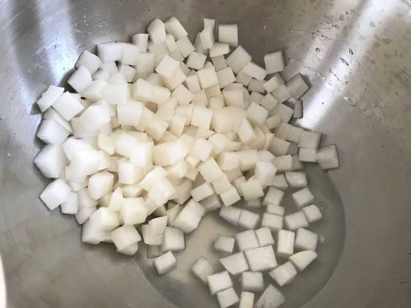 Water seeping out of cubed daikon in a bowl