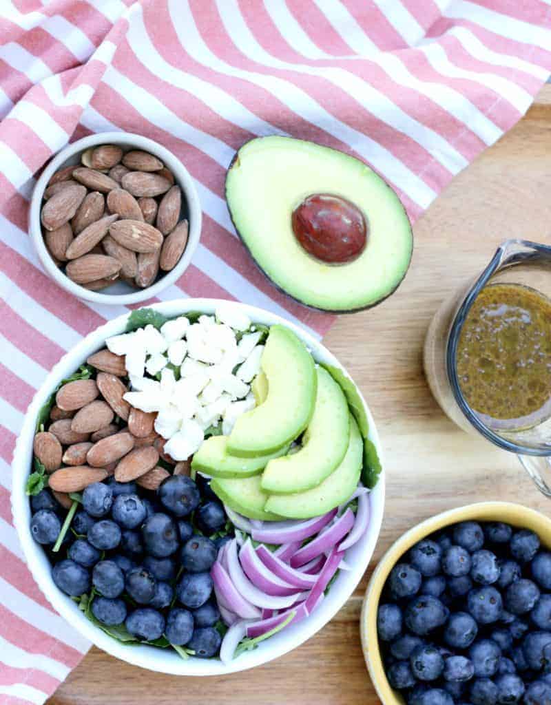 A blueberry salad with avocado and feta cheese