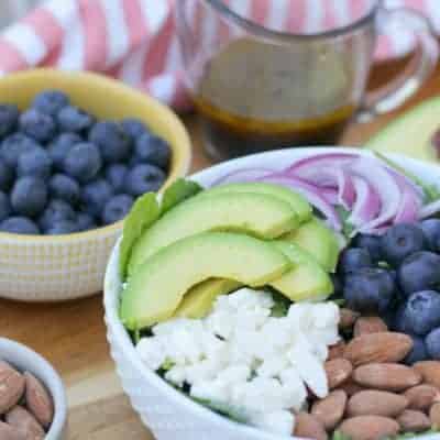 A blueberry salad with avocado and feta cheese