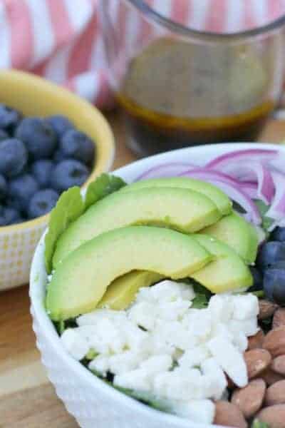 A blueberry salad with avocado and feta cheese