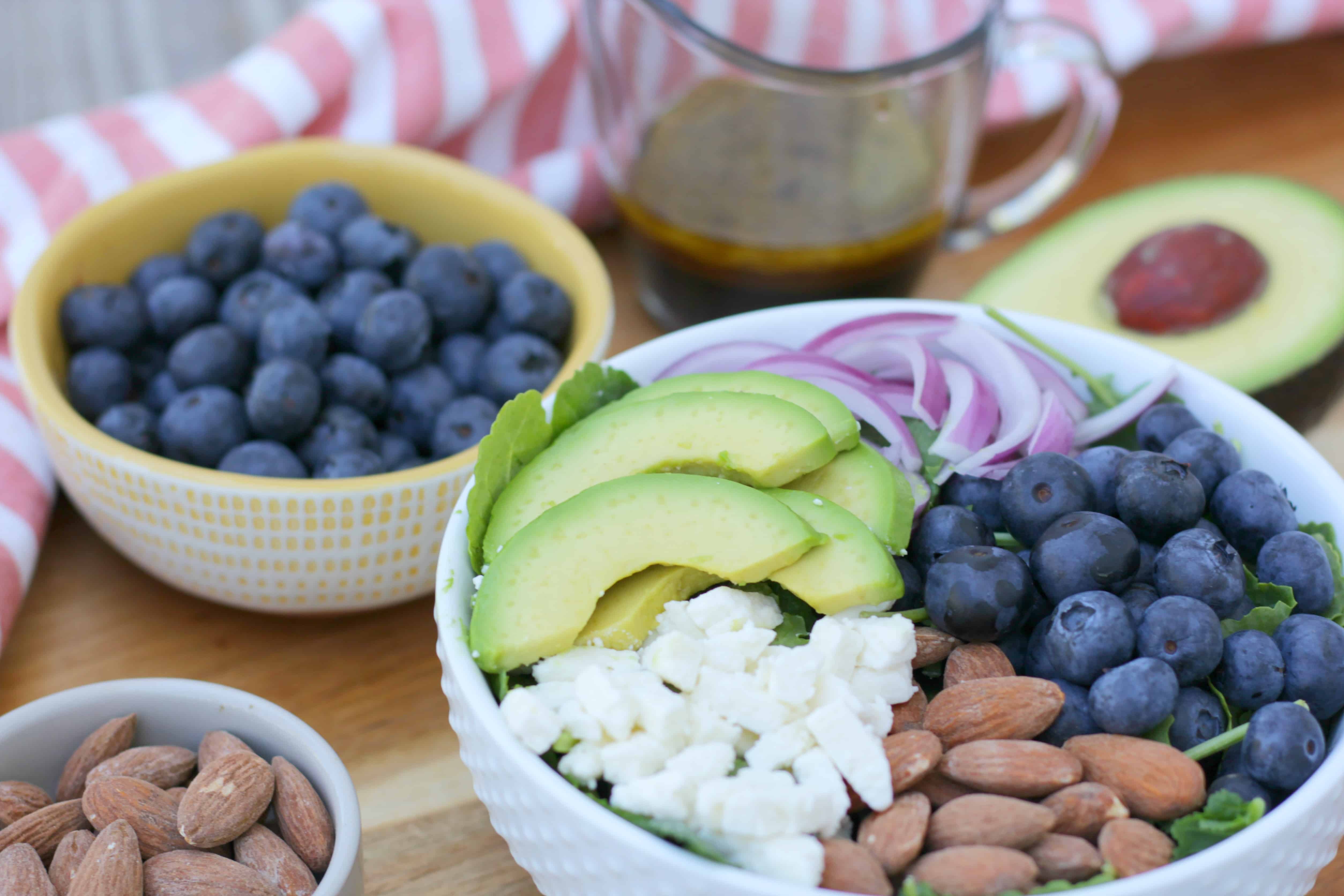 A blueberry salad with avocado and feta cheese