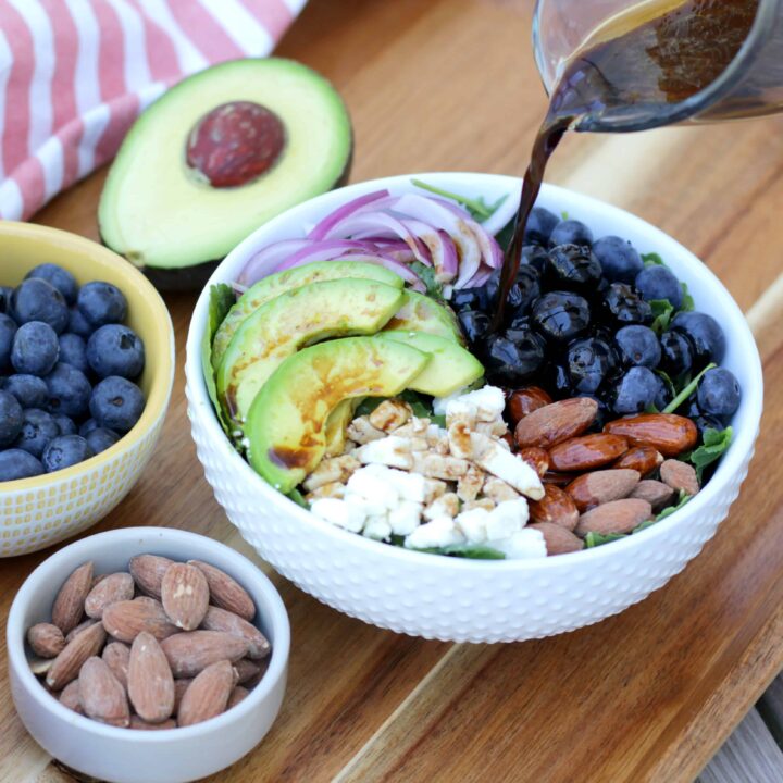 A blueberry salad with avocado and feta cheese