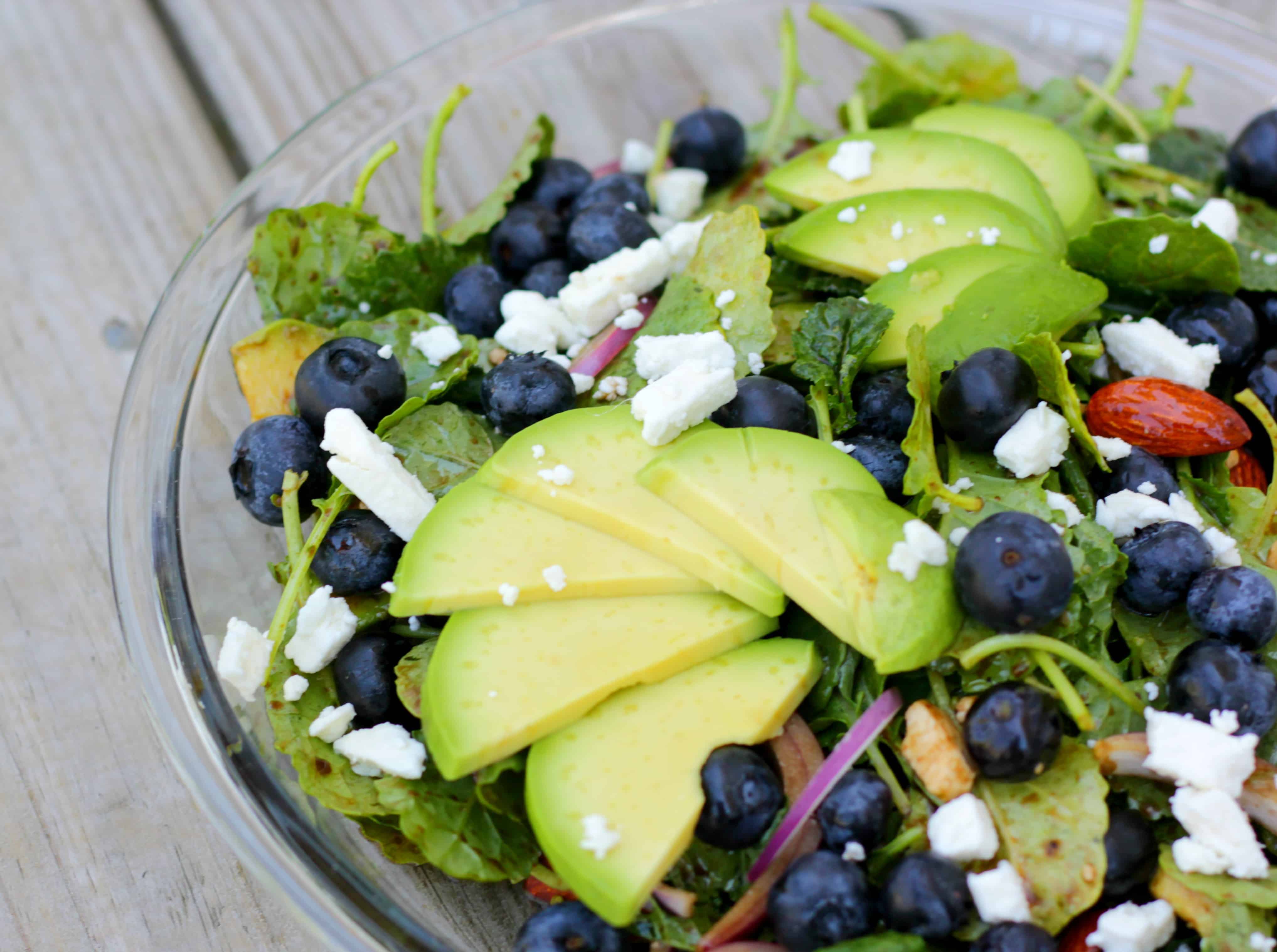 A blueberry salad with avocado and feta cheese