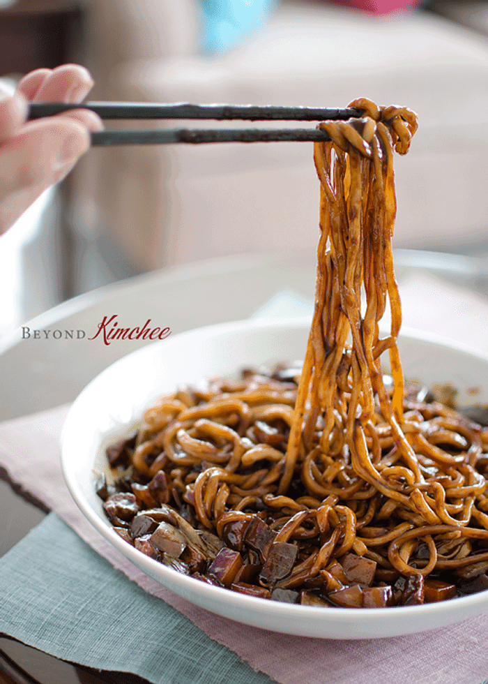 Korean black bean noodles being eaten