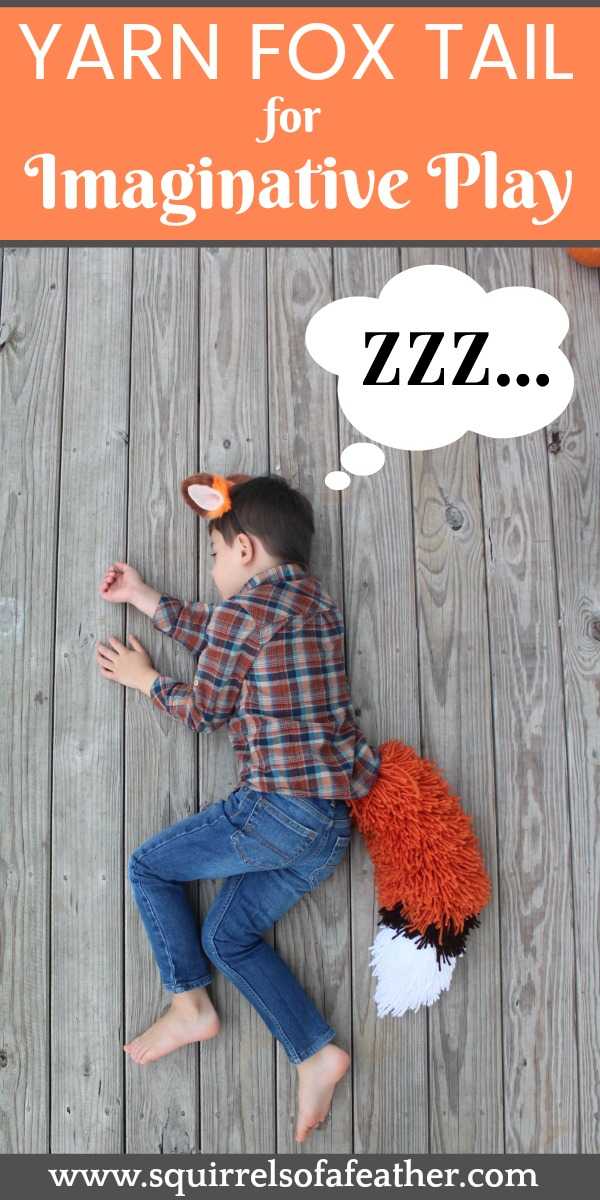 A boy wearing a fox tail costume