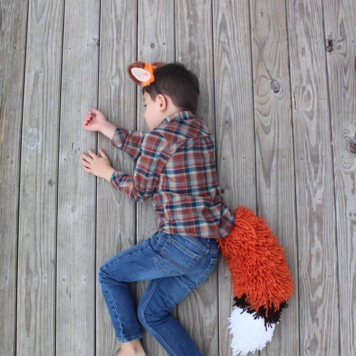 Boy sleeping in his fox tail costume