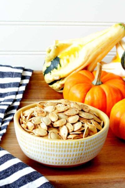 A plate full of pumpkin seeds and gourds