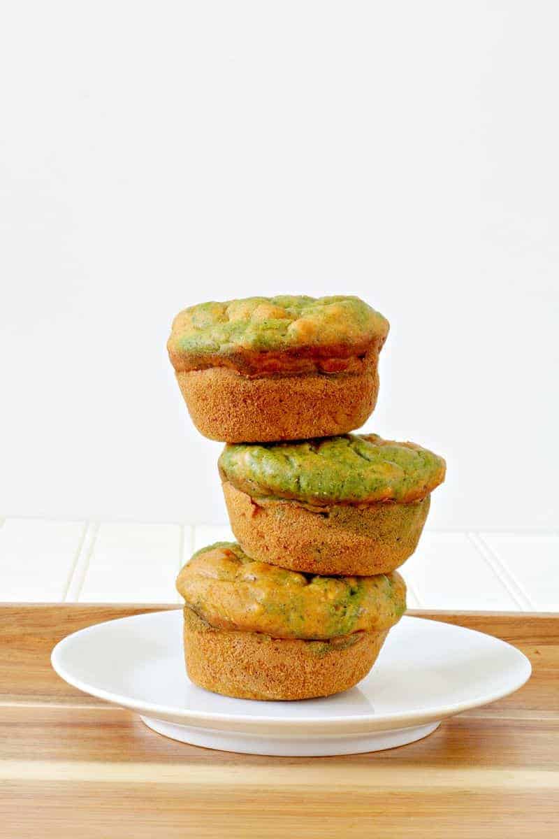 Three butternut squash muffins piled on a plate