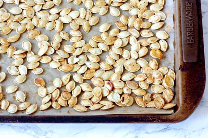 Roasted pumpkin seeds on a baking pan