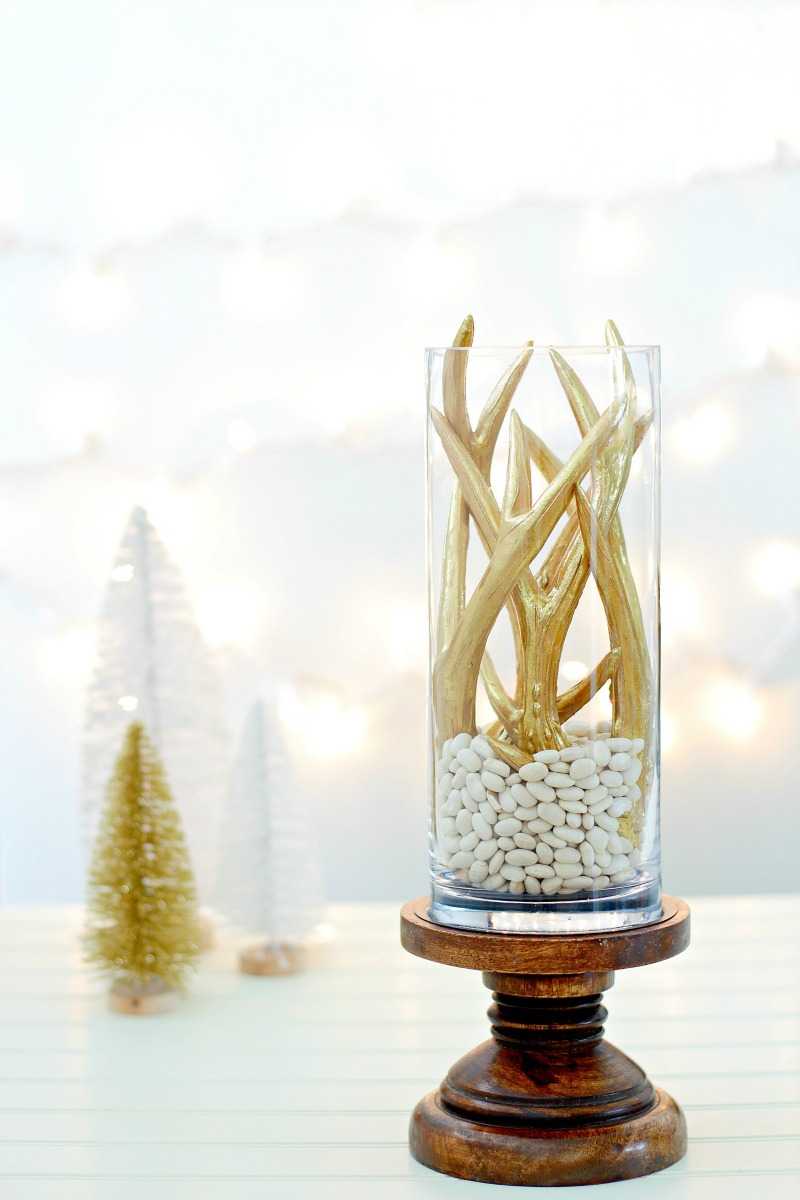 A Christmas centerpiece with white lights behind