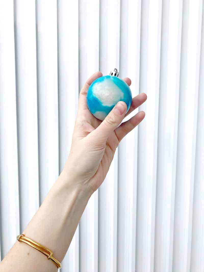 A hand holding an edible ornament
