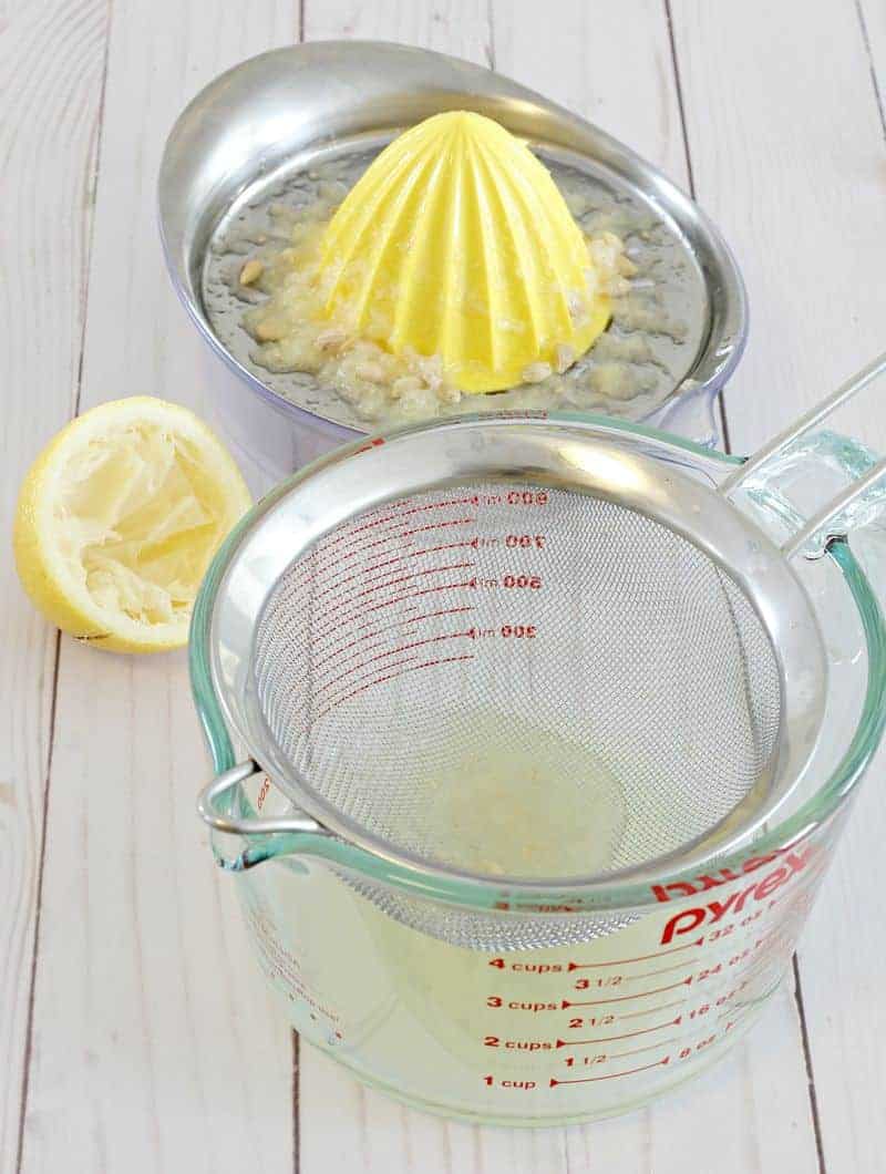 Straining lemon for rosewater jelly