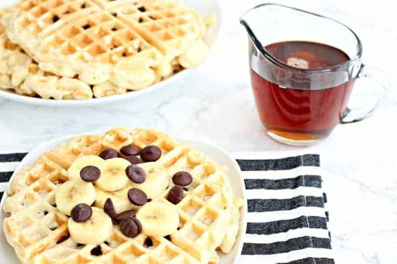 A table with chocolate chips waffles and syrup