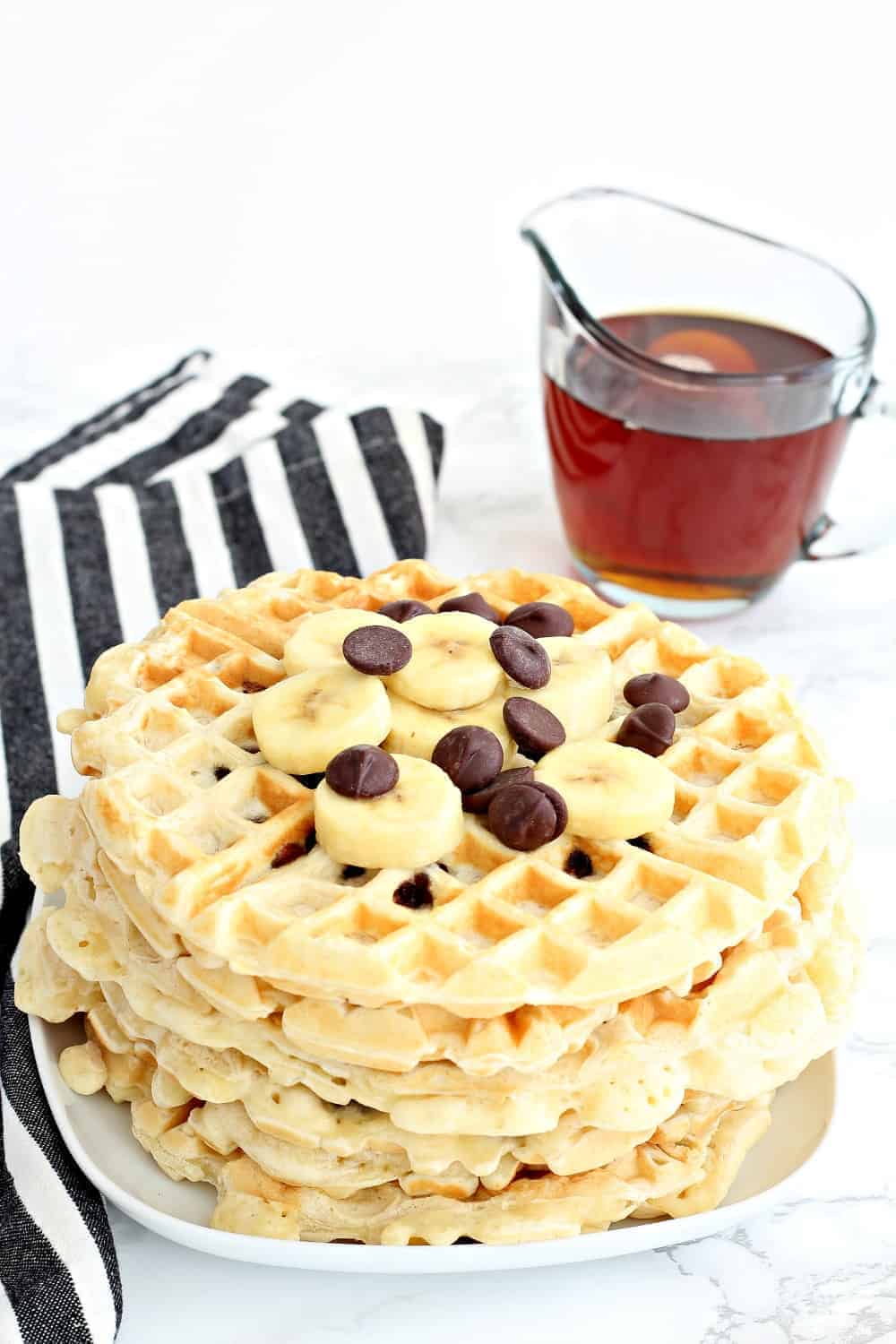Chocolate chip waffles topped with chocolate chips and bananas