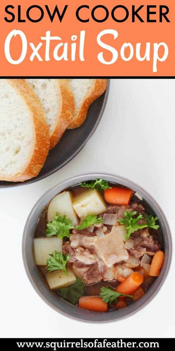 Slow cooker oxtail soup in a bowl next to bread