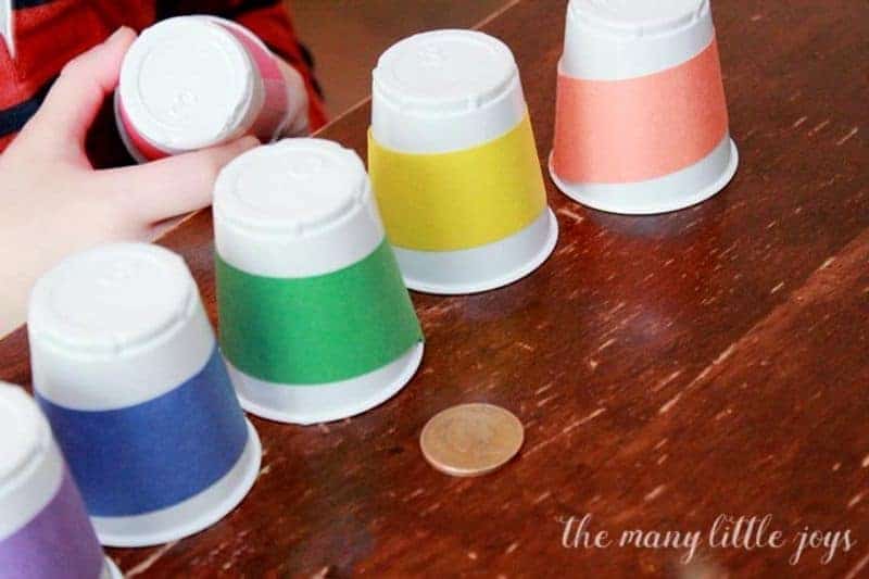 A colorful St. Patrick's Day activity with cups and gold coin