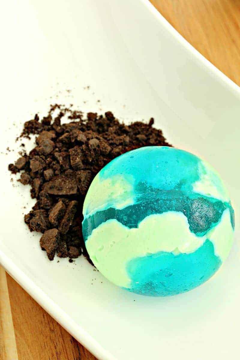 Close up of Jello ball next to Oreo dirt