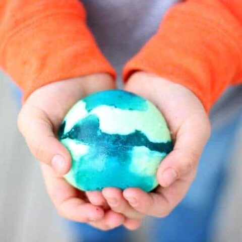 Boy holding blue and green jello ball