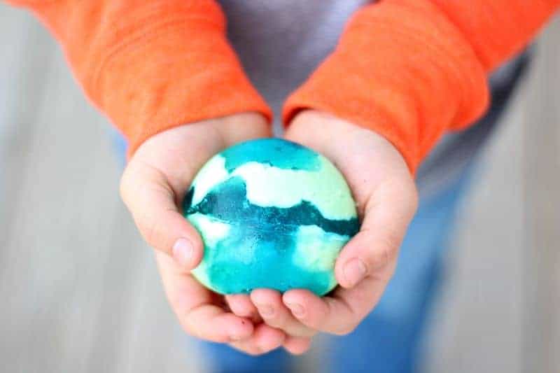 Boy holding blue and green jello ball