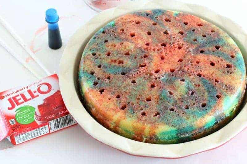 Pouring Jello into poke cake holes