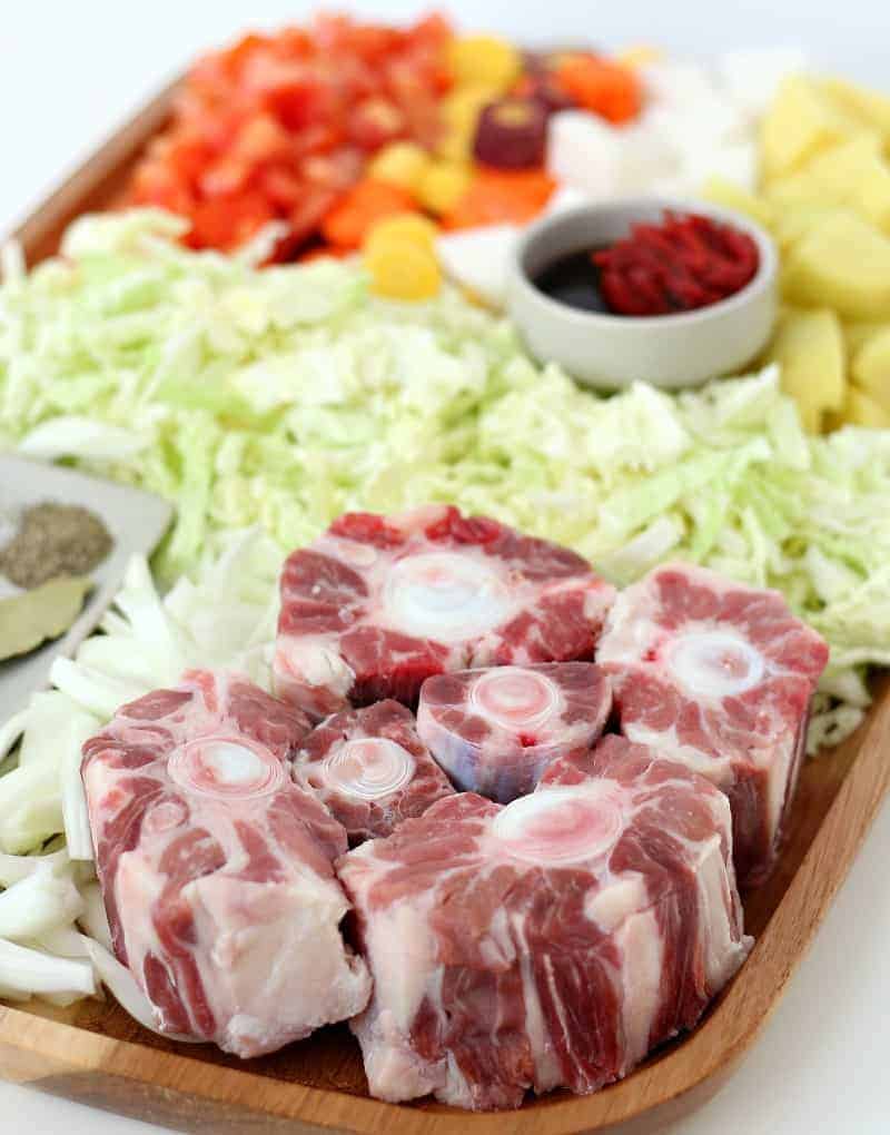 Fresh oxtail and vegetables on a tray