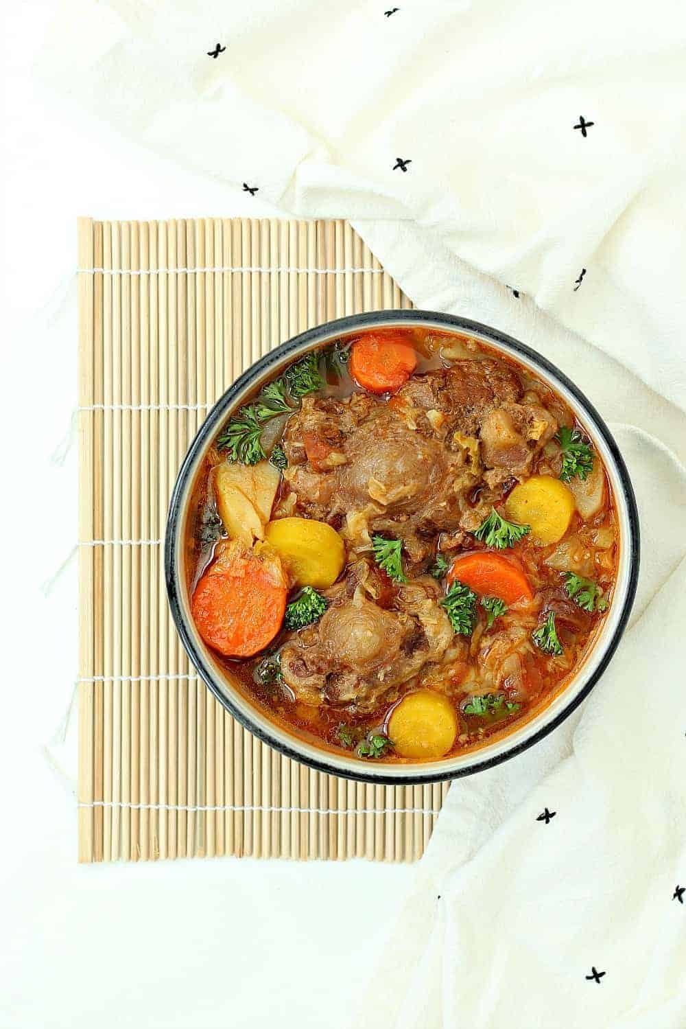 Instant Pot oxtail soup in a bowl on a table