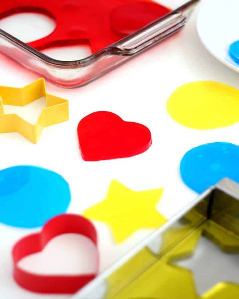 Colorful Jello Jigglers being cut on a table