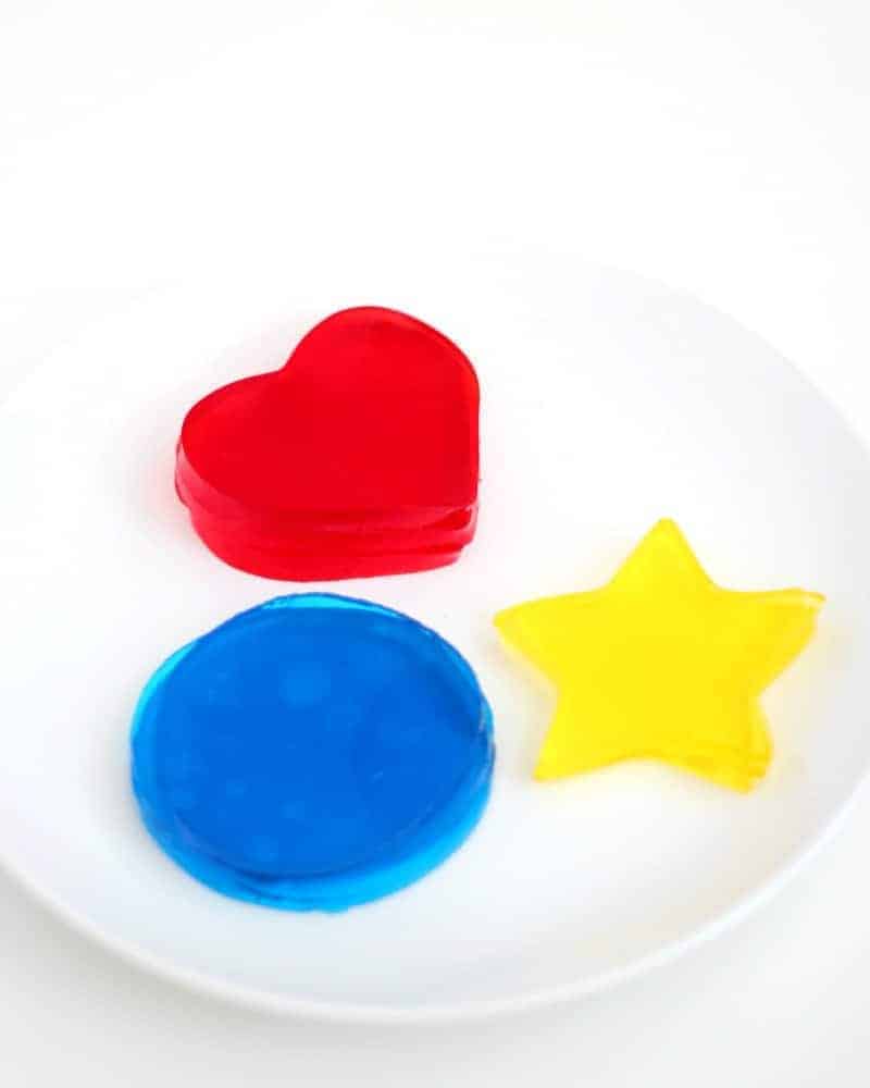 Red, blue, and yellow Jello Jigglers on a plate