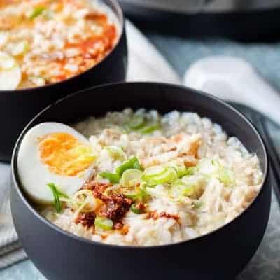 Instant Pot chicken soup congee in a black bowl