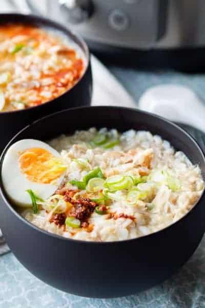 Instant Pot chicken soup congee in a black bowl