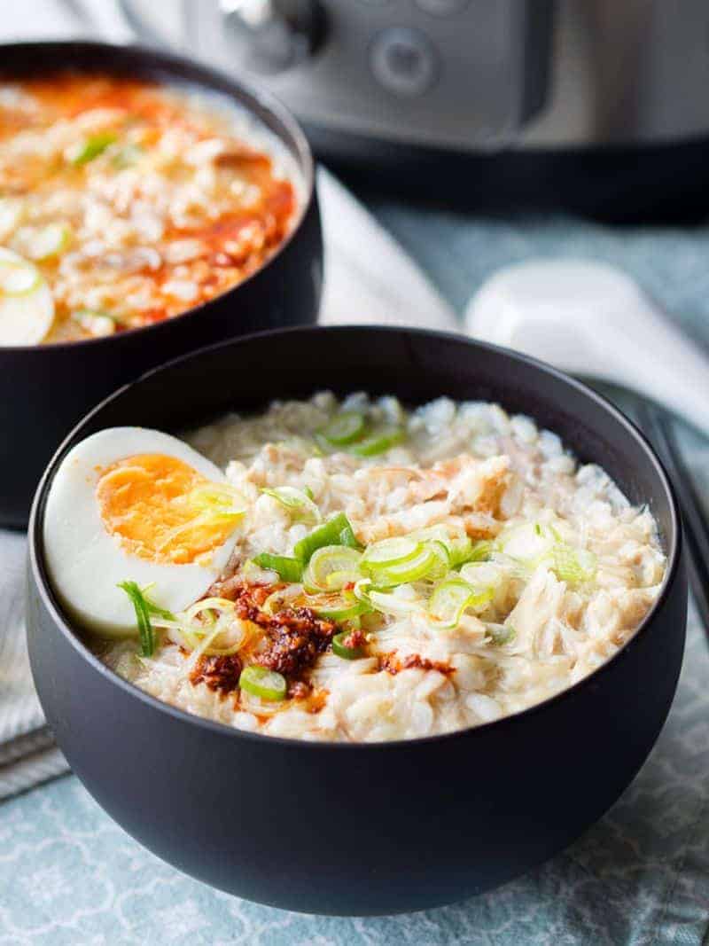 Instant Pot chicken soup congee in a black bowl