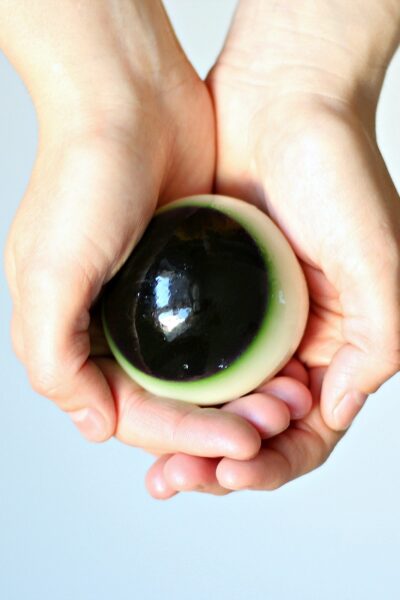 Close up of hand holding eyeball jello shot