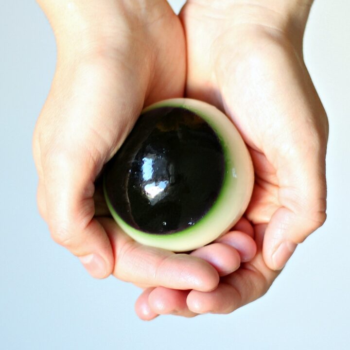 Close up of hand holding eyeball jello shot