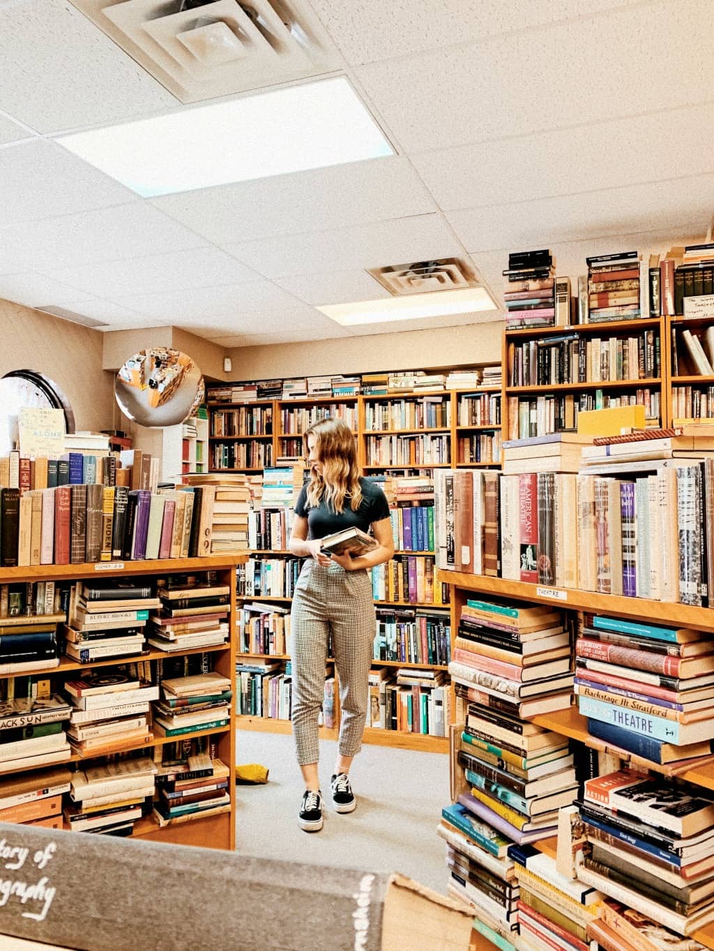 A woman shopping at a thrift store for stuff to sell online.