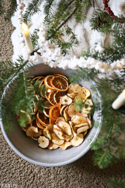 A pan of dried oranges and apples being put on the Chri