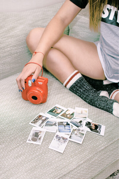 A girl using photos and other vision board supplies