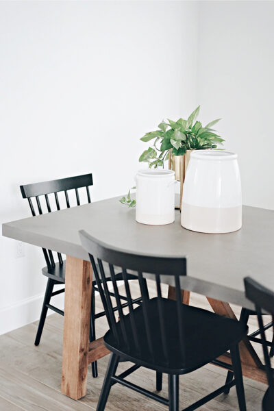 A minimalist table with black chairs