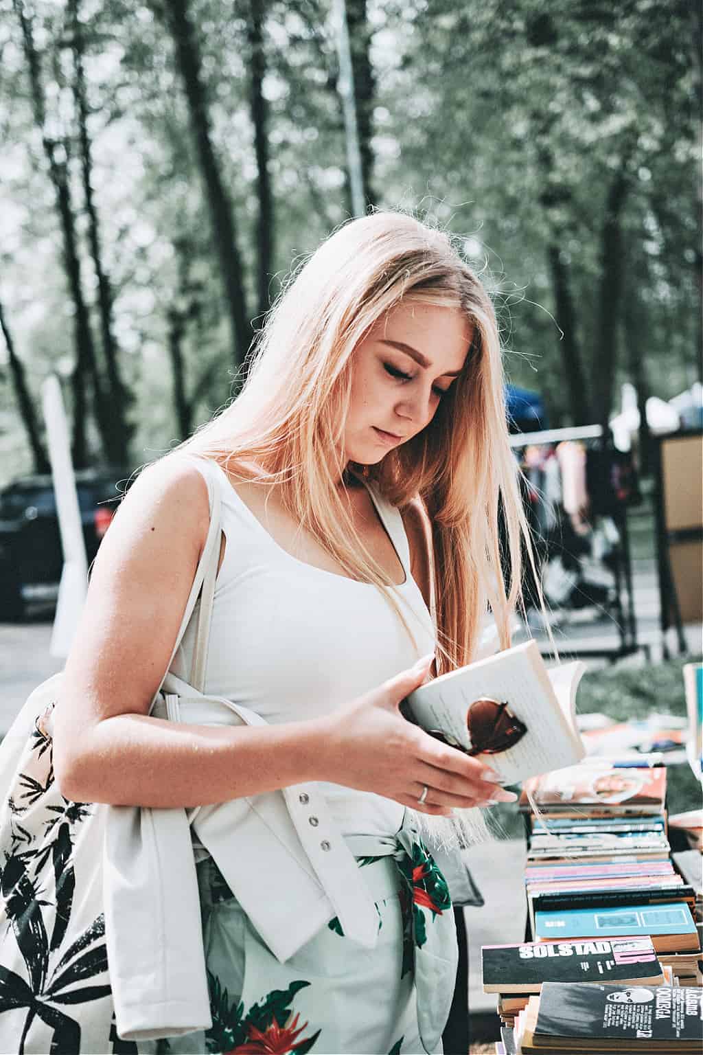 A woman using good minimalist shopping habits to save money on a book