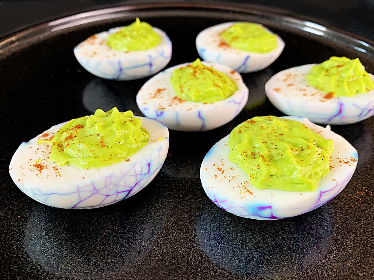 Closet up of Halloween deviled eggs on a black plate
