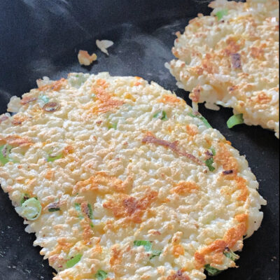 close up of two rice pancakes in a pan