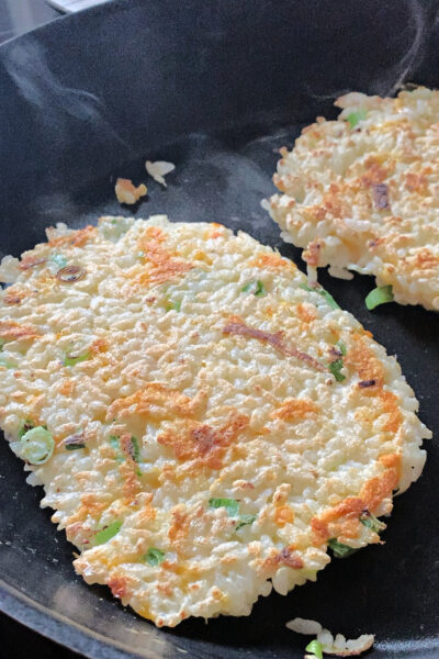 close up of two rice pancakes in a pan