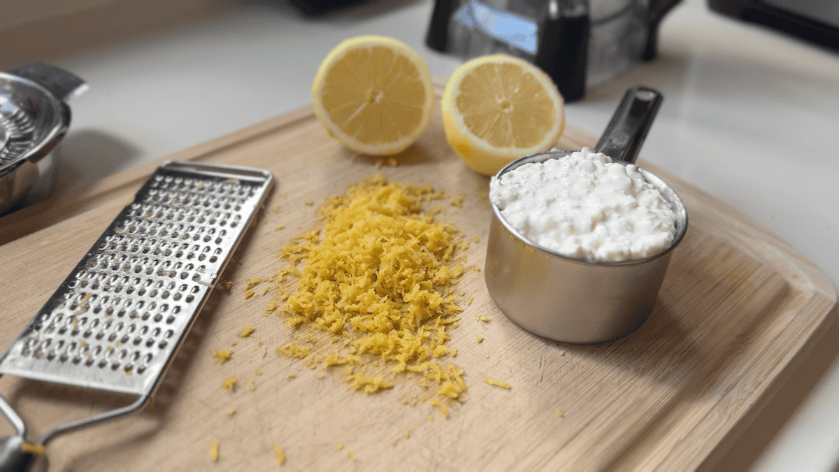 Ingredients to make protein cheesecake on a white countertop